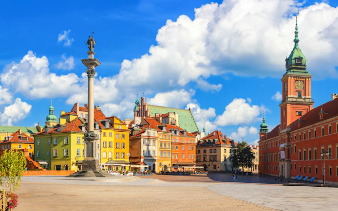 Castle Square with Royal Castle and colorful buildings in Warsaw, Poland.