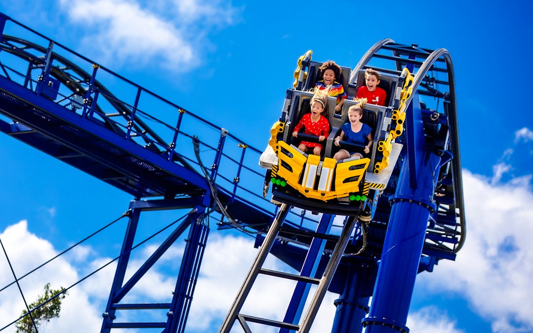 Riders on The Great LEGO Race roller coaster at Legoland Florida.
