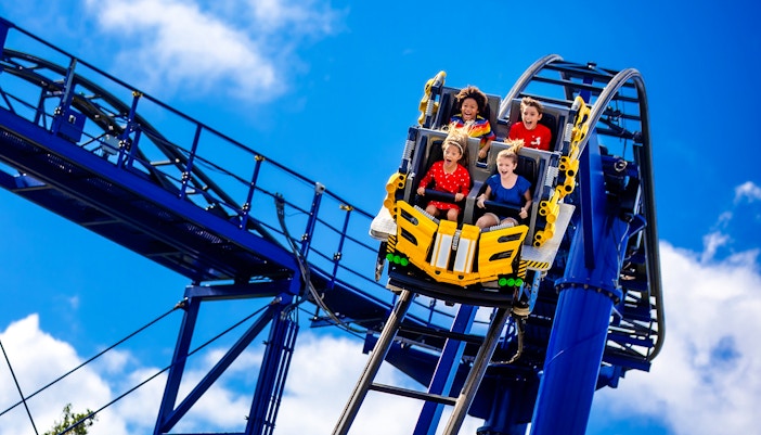 Riders on The Great LEGO Race roller coaster at Legoland Florida.