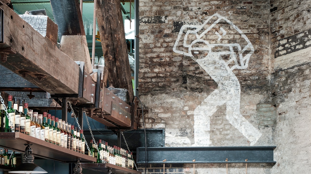 Jameson Distillery tour guide explaining whiskey production process in Dublin, Ireland.