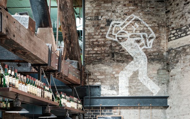 Jameson Distillery interior with whiskey bottles and industrial decor.