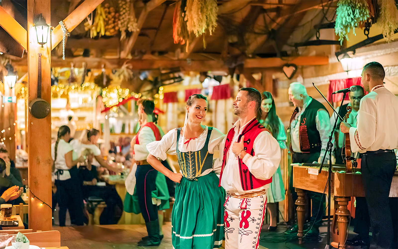 Prague folklore dinner show with dancers in traditional costumes and live musicians.