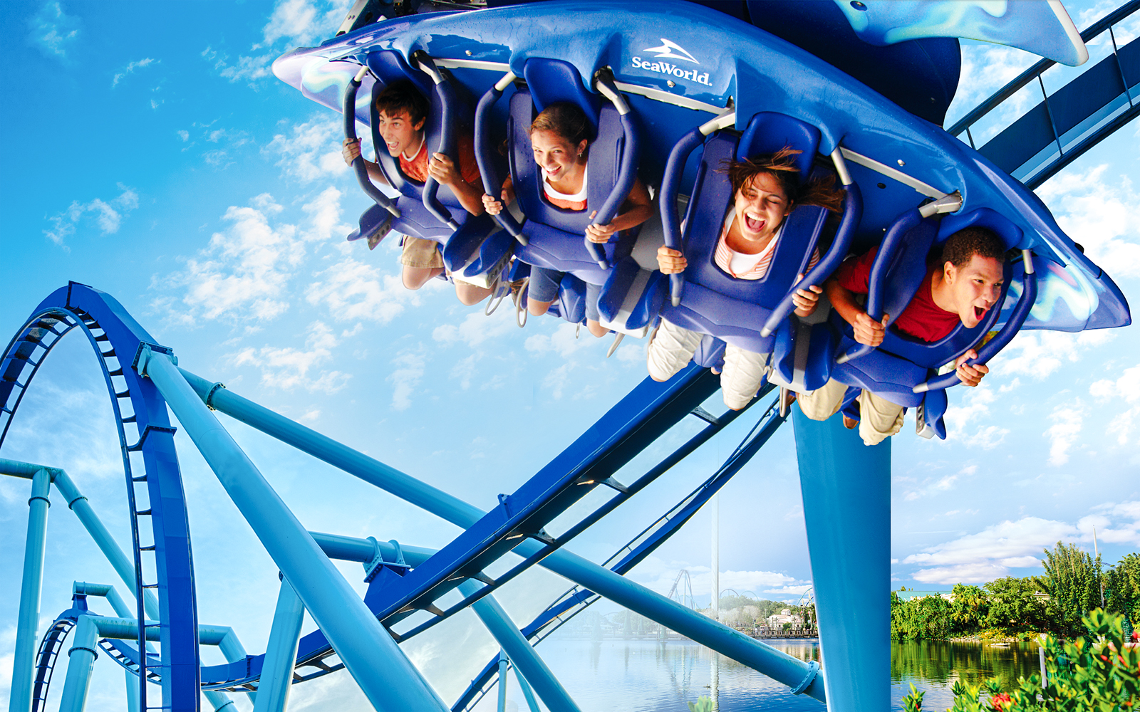 Riders on Manta roller coaster at SeaWorld, Orlando, experiencing a thrilling loop.