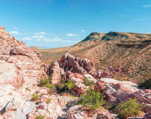 Red Rock Canyon National Conservation Area with layered red rock formations and desert landscape.