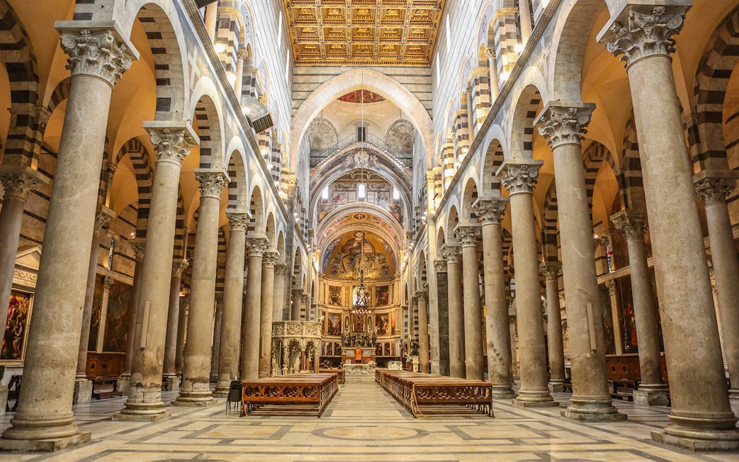 Interior of Pisa Cathedral with ornate columns and arches, part of a guided tour from Florence.
