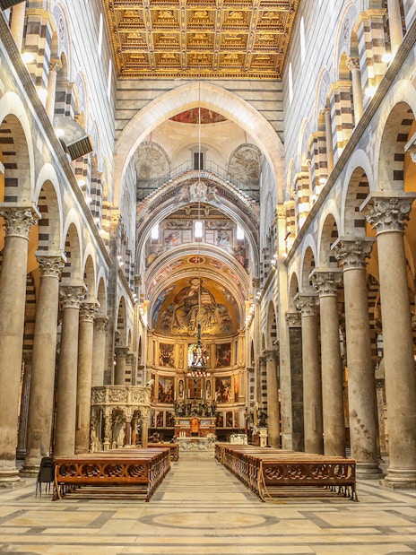 Interior of Pisa Cathedral with ornate columns and arches, part of a guided tour from Florence.
