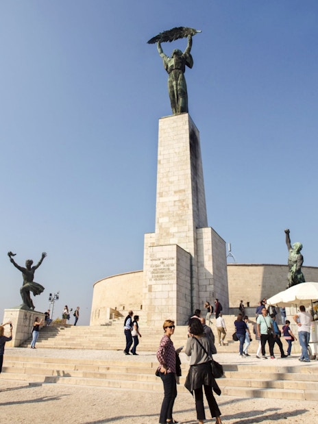 Liberty Statue on Gellert Hill with visitors, Budapest, Hungary.
