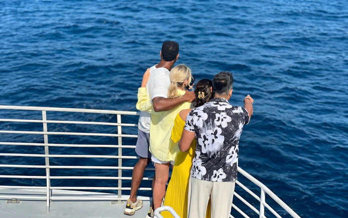 Group enjoying ocean view on Los Angeles Harbor sightseeing cruise.