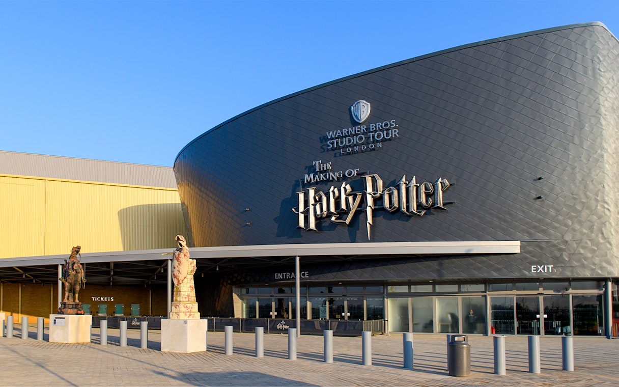 Warner Bros. Studio Tour London entrance with Harry Potter-themed statues.