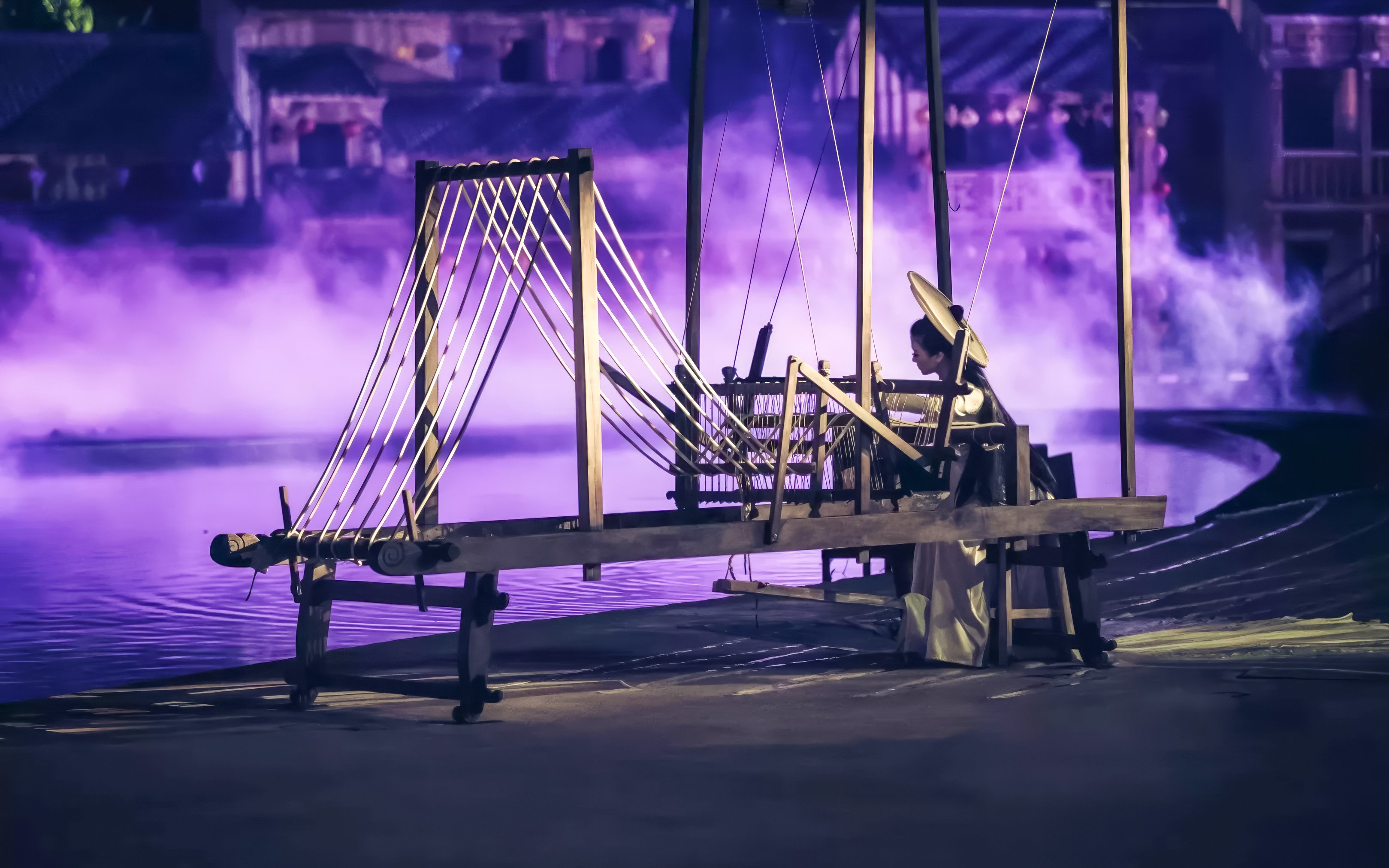 Traditional weaver performing at Hoi An Memories Show, Vietnam.