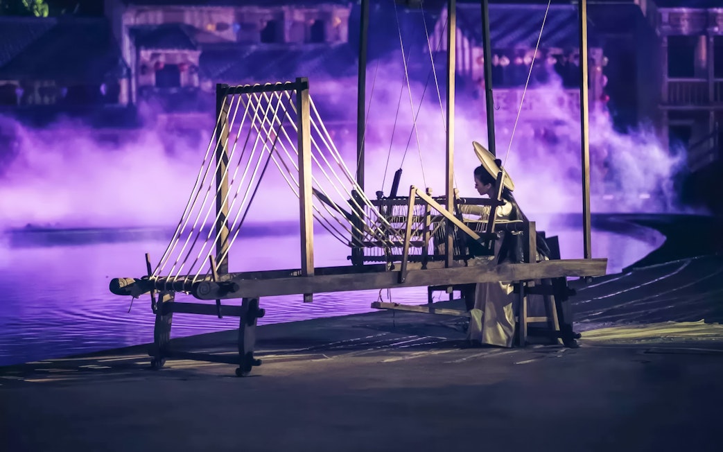 Traditional weaver performing at Hoi An Memories Show, Vietnam.