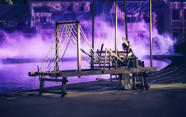 Traditional weaver performing at Hoi An Memories Show, Vietnam.