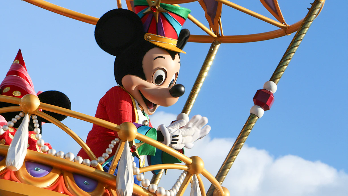 Mickey Mouse waving during a parade at Walt Disney World, Orlando.