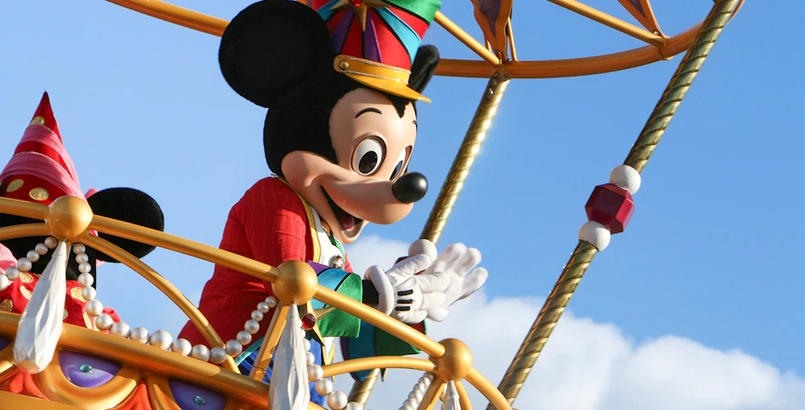 Mickey Mouse waving during a parade at Walt Disney World, Orlando.