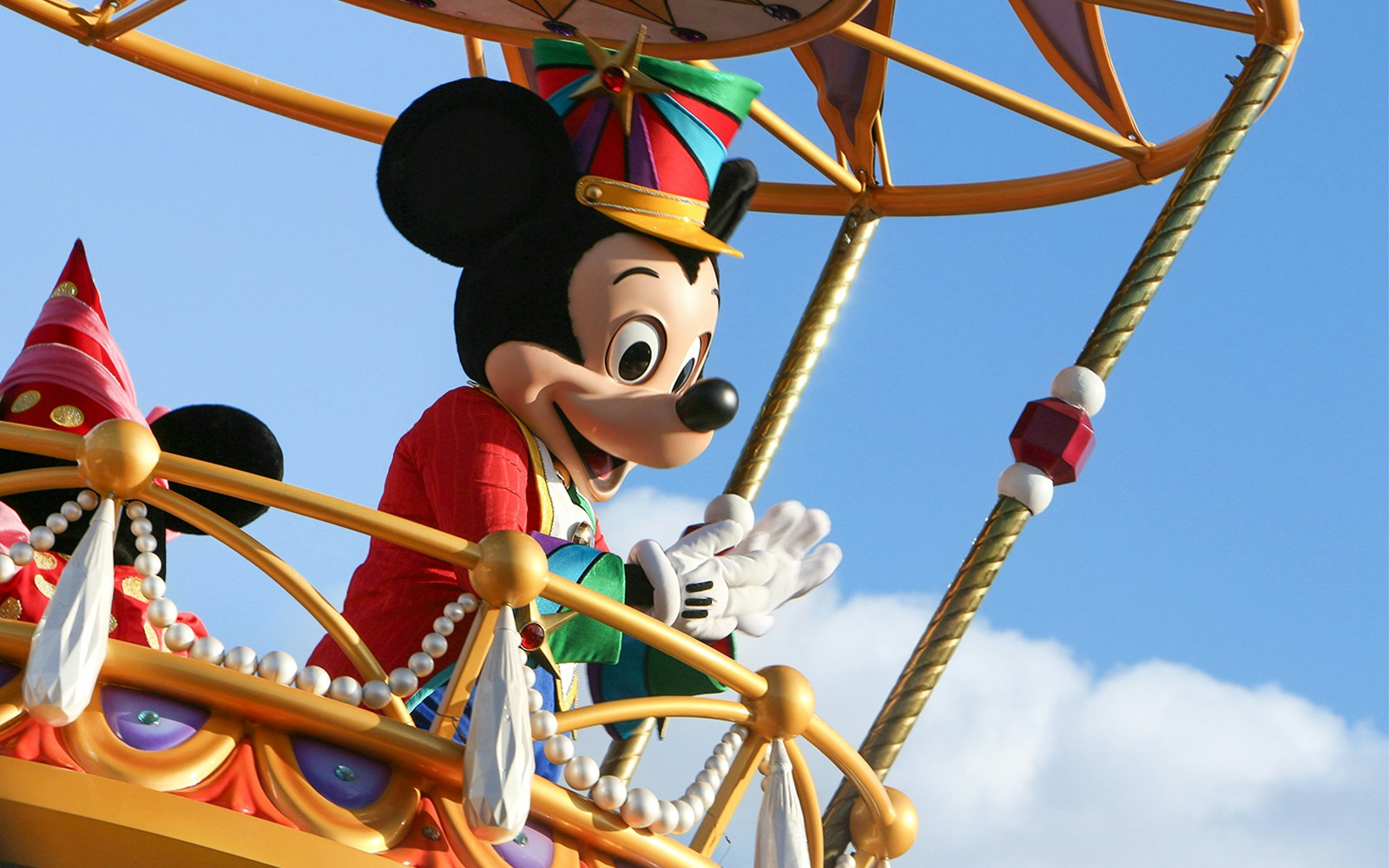 Mickey Mouse waving during a parade at Walt Disney World, Orlando.