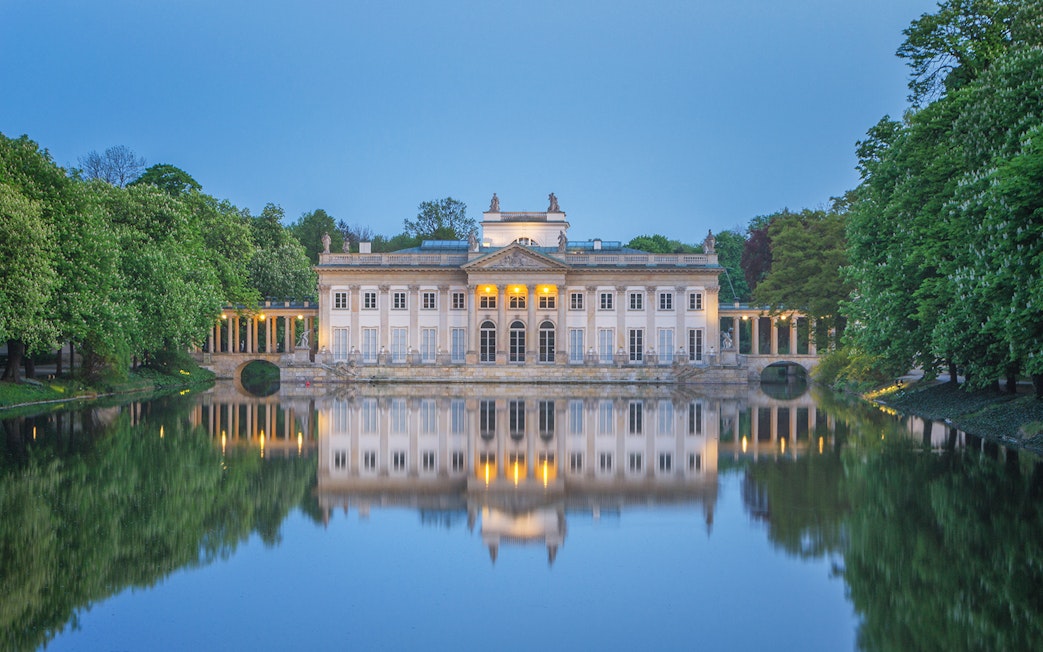 Lazienki Palace reflecting on water in Warsaw, Poland, included in Warsaw Pass.