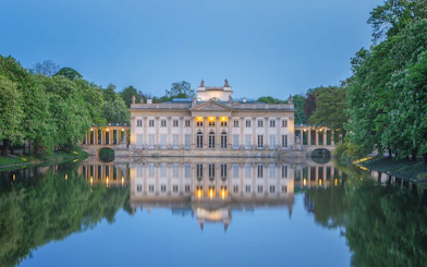 Lazienki Palace reflecting on water in Warsaw, Poland, included in Warsaw Pass.