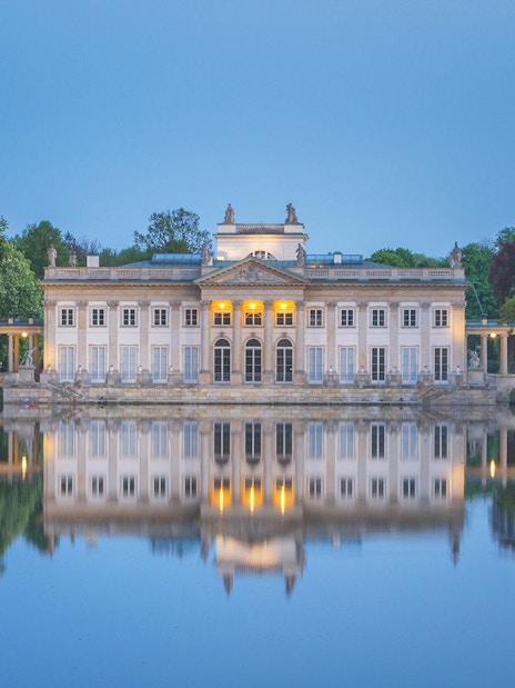 Lazienki Palace reflecting on water in Warsaw, Poland, included in Warsaw Pass.