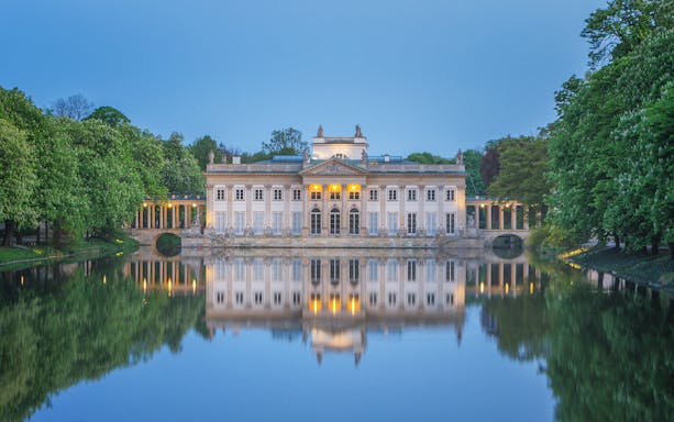 Lazienki Palace reflecting on water in Warsaw, Poland, included in Warsaw Pass.