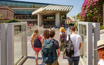 Group entering Acropolis Museum entrance in Athens.