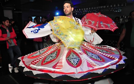 Dancer performing traditional Tanoura dance on Nile River dinner cruise.
