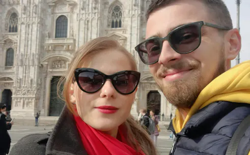 Couple in front of Milan Cathedral during self-guided city exploration game.
