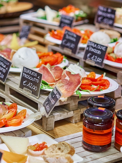 Florence food tour display with burrata, prosciutto, and local cheeses.