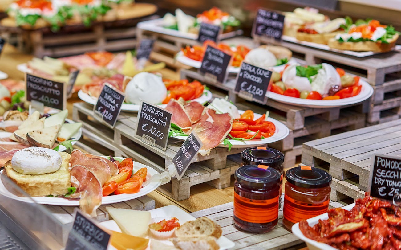 Florence food tour display with burrata, prosciutto, and local cheeses.