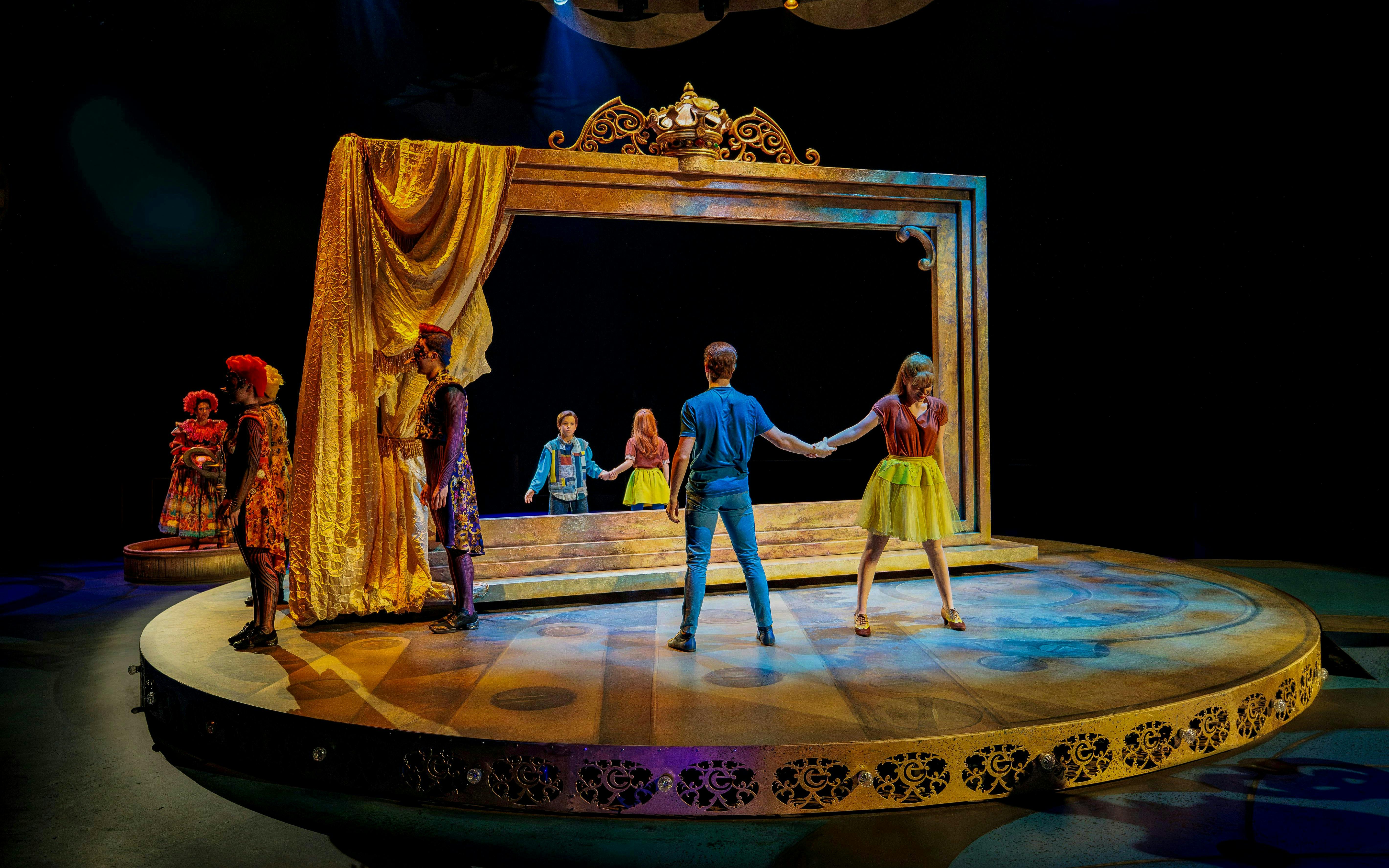 Performers on stage at CARO Theatre Show, Efteling Amsterdam, with a large ornate frame.
