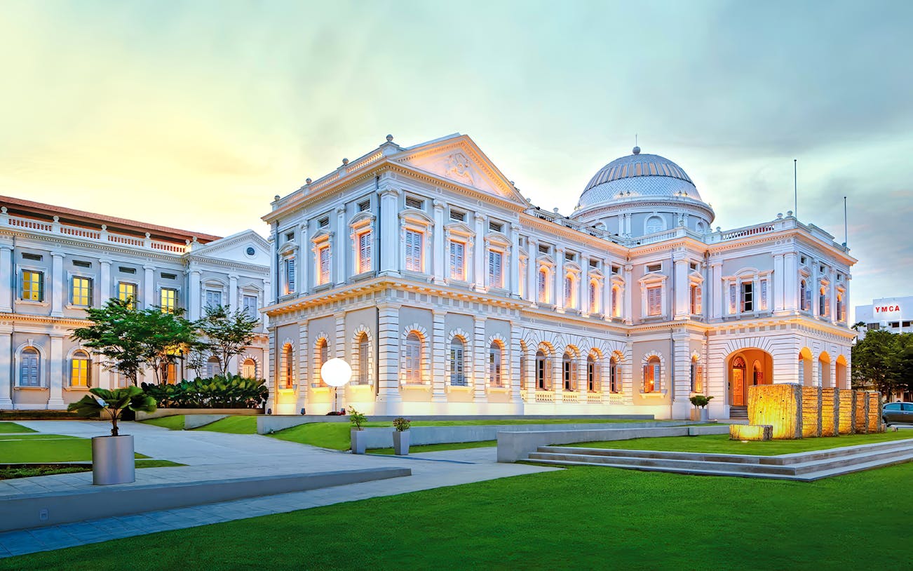 National Museum of Singapore exterior with illuminated facade at dusk.