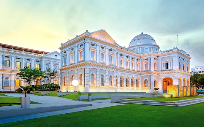 National Museum of Singapore exterior with illuminated facade at dusk.