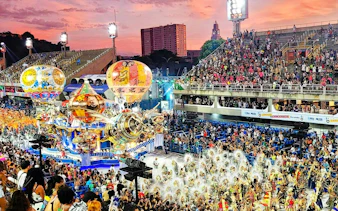 Aerial view of Rio Carnival parade with colorful floats and dancers in Sambadrome.