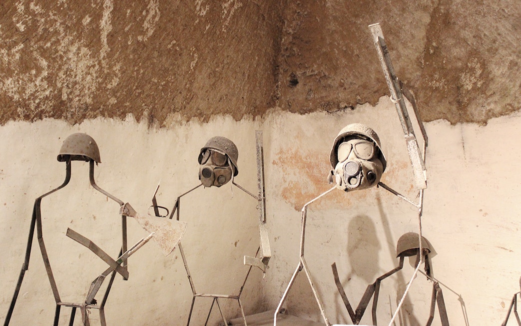 Naples Underground display of metal figures with military helmets and gas masks.
