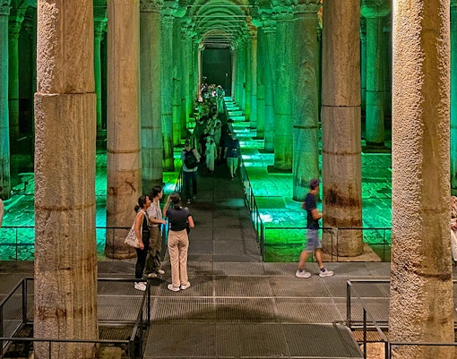 Tourists capturing the Basilica Cistern on an Old City Walking tour, Blue Mosque and Bosphorus Cruise visible.