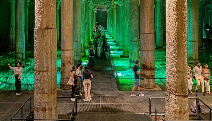 Tourists capturing the Basilica Cistern on an Old City Walking tour, Blue Mosque and Bosphorus Cruise visible.
