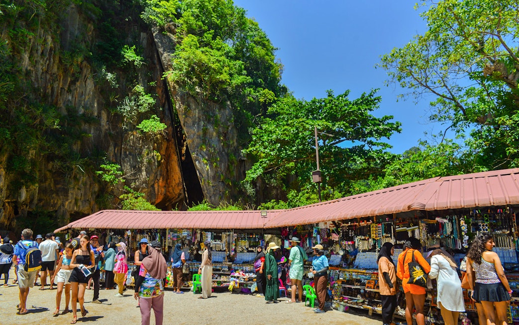 Tourists browsing market stalls at James Bond Island, Phang Nga Bay.