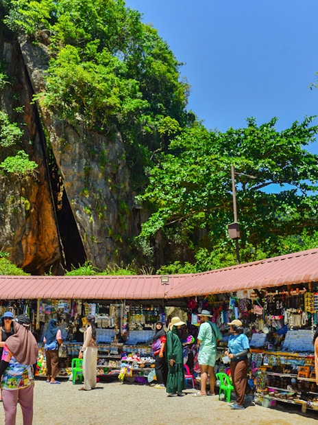 Tourists browsing market stalls at James Bond Island, Phang Nga Bay.