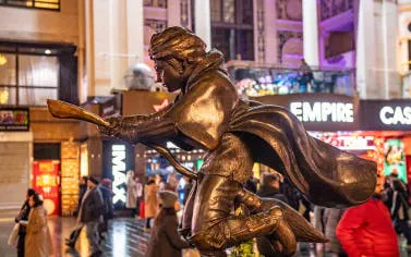 Statue of Harry Potter on broomstick in London's Leicester Square during Christmas.