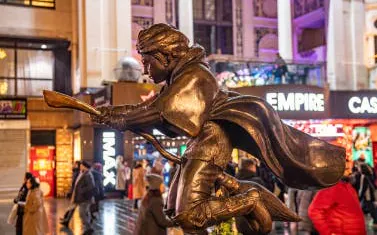 Statue of Harry Potter on broomstick in London's Leicester Square during Christmas.