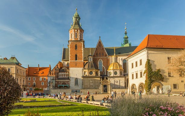 Wawel Cathedral in Krakow with tourists exploring the historic site.