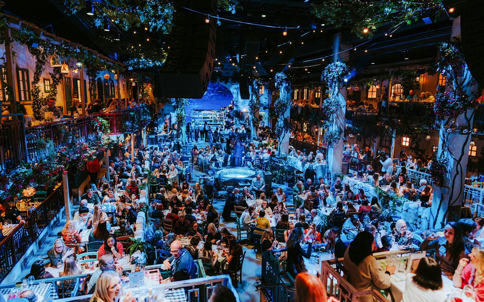 Crowd enjoying dinner and entertainment at Mamma Mia! The Party venue.