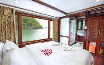Cruise cabin with large window view of Halong Bay, Vietnam.