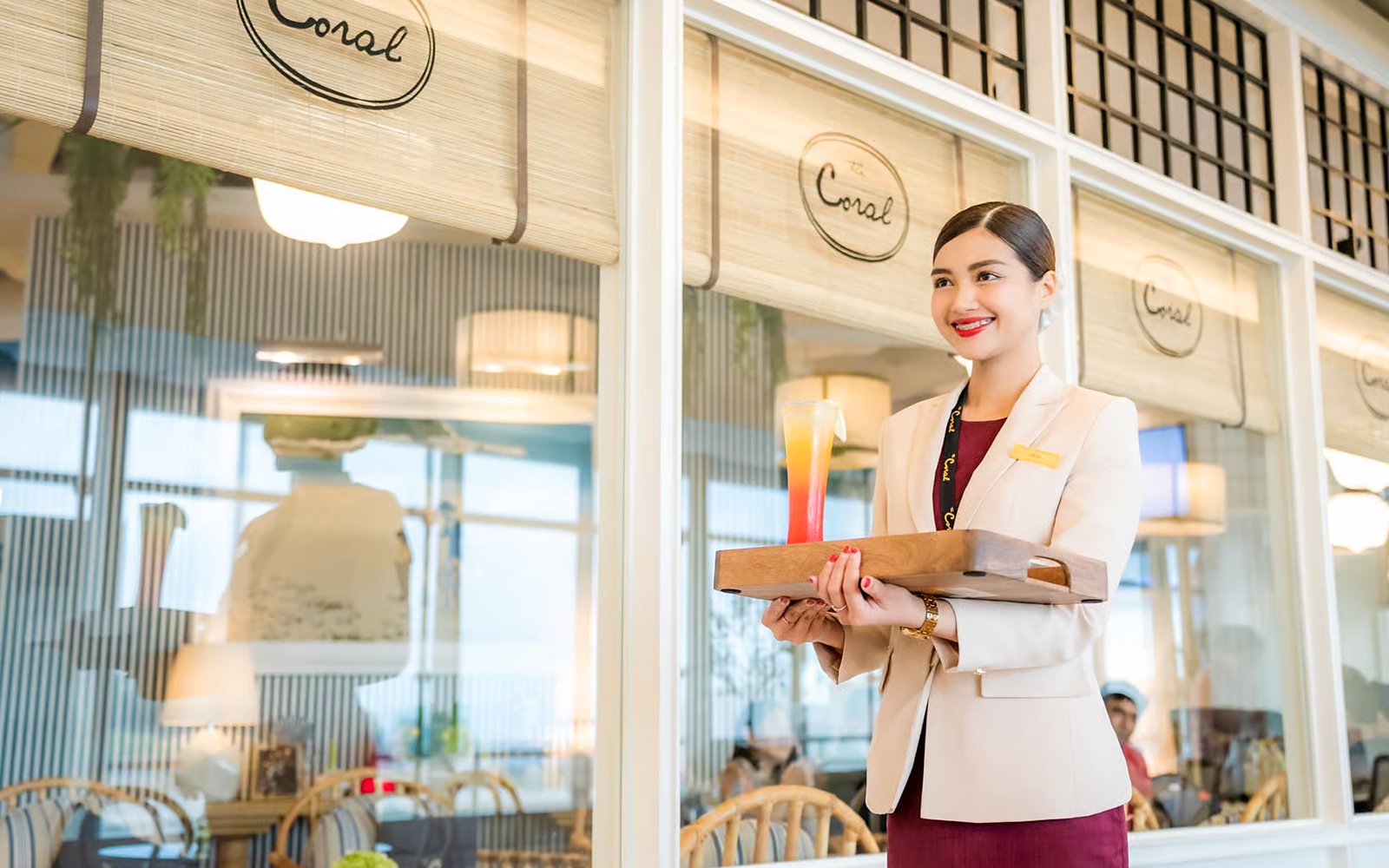 VIP lounge service at Donmuang Airport with staff serving a drink.