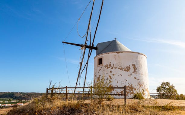 Old windmill on a hill during a Full-Day Jeep Tour in Algarve.