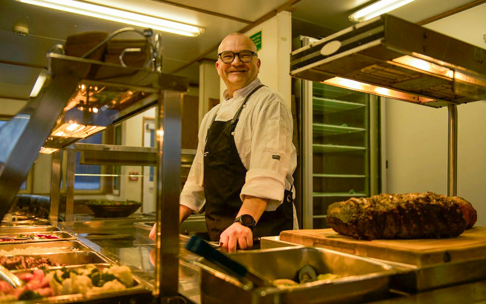 Chef preparing buffet on Doubtful Sound overnight cruise from Queenstown.