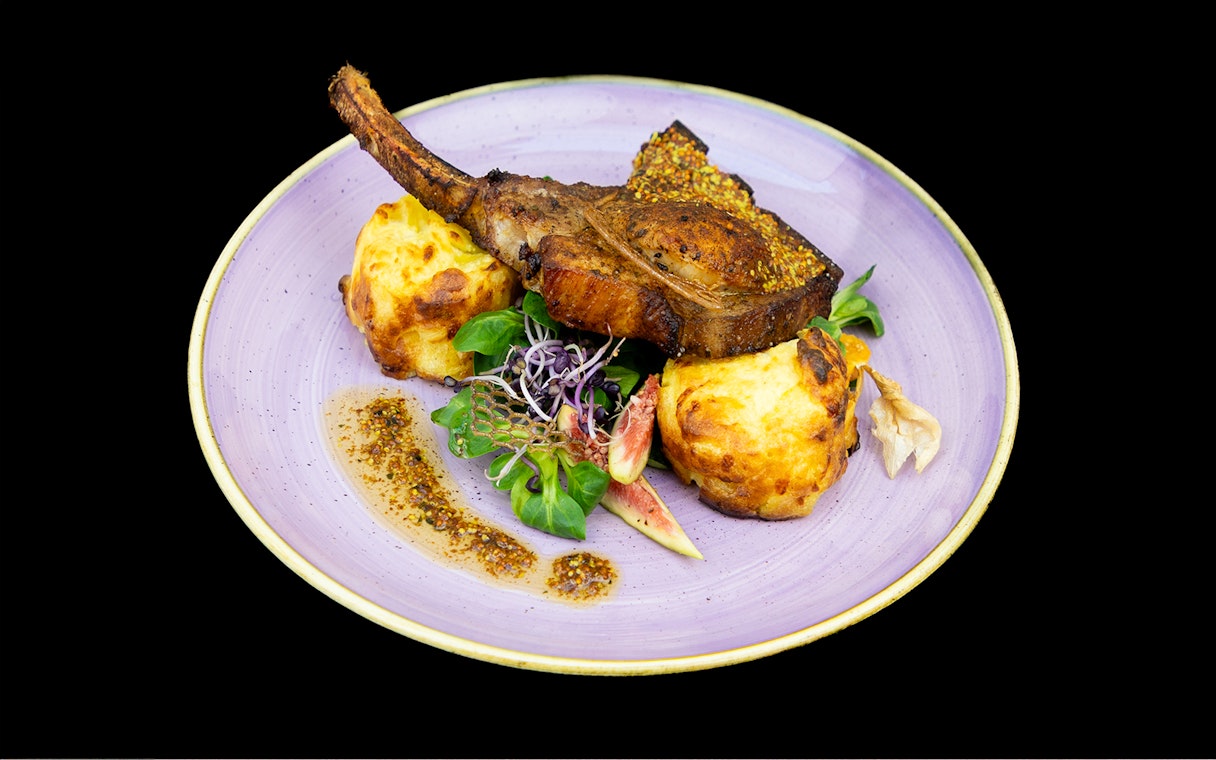 Grilled lamb chop with mashed potato and fig garnish on Budapest Dinner Cruise.