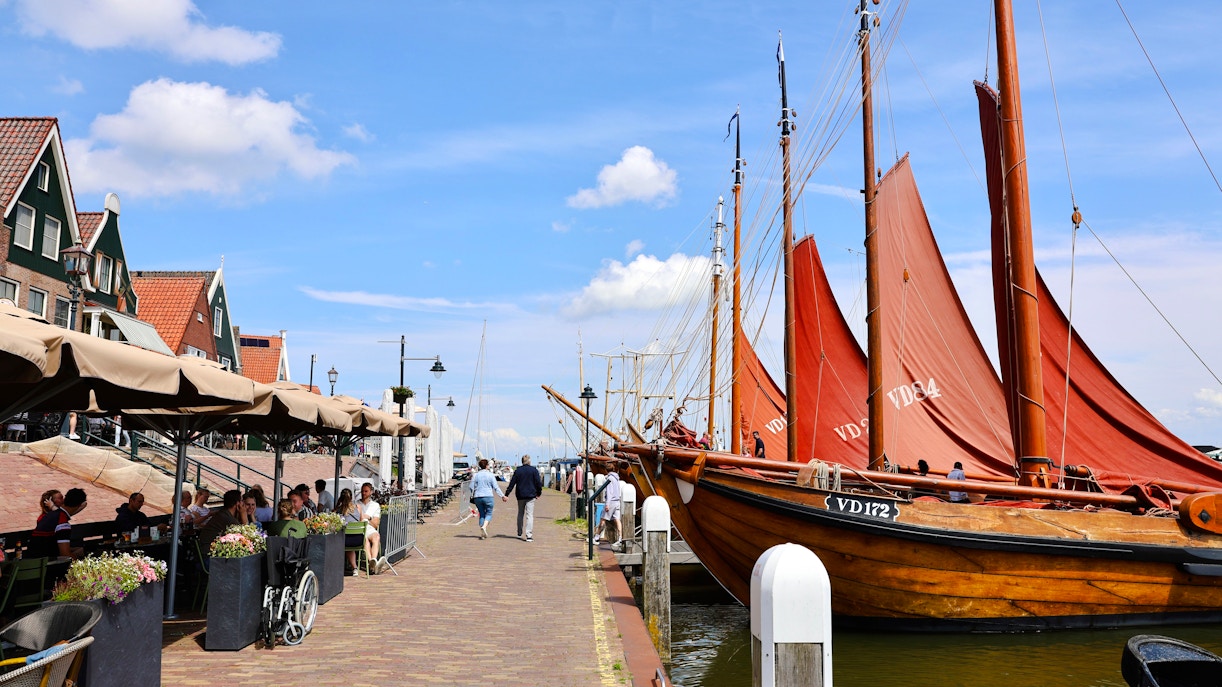 Volendam harbor with traditional boats and charming street cafes.