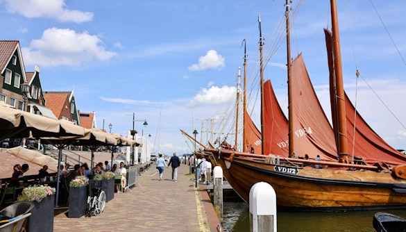Volendam harbor with traditional boats and charming street cafes.