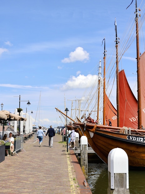 Volendam harbor with traditional boats and charming street cafes.