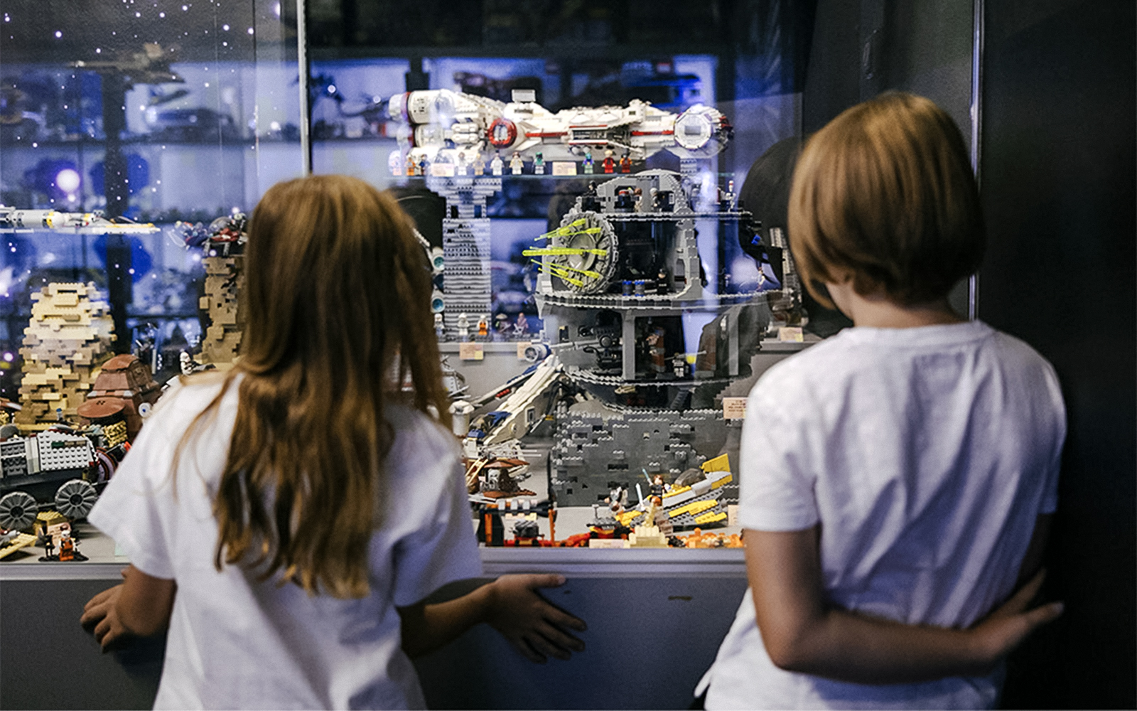Children viewing a detailed LEGO Star Wars display at the Museum of Bricks.